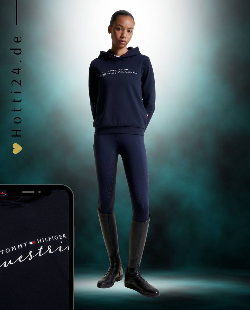 Damen-Hoodie von Tommy Hilfiger mit der Bezeichnung "Metallic TH08WHOO438-004" in der Farbe Blau. Dieser Hoodie ist auf der Webseite www.hotti24.de erhältlich. Er wurde speziell für Damen entworfen, um sowohl Stil als auch Komfort zu bieten.  Die Datei enthält auch Bilder des Hoodies aus verschiedenen Blickwinkeln, darunter die Vorderseite, die Seite und die Rückseite. Diese visuellen Darstellungen ermöglichen es Ihnen, das Design und die Eigenschaften des Hoodies besser zu verstehen